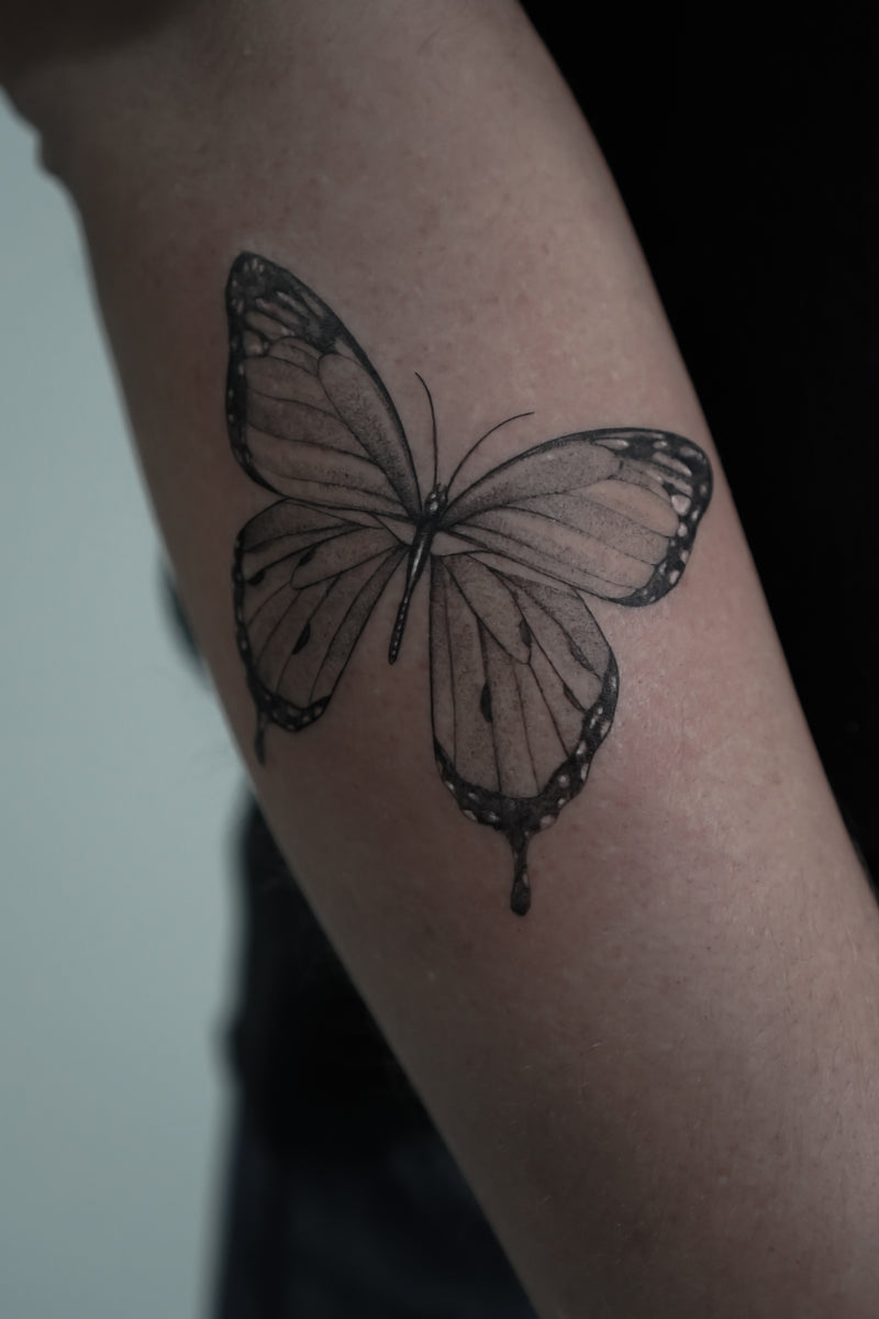 Fine line butterfly tattoo by Inko