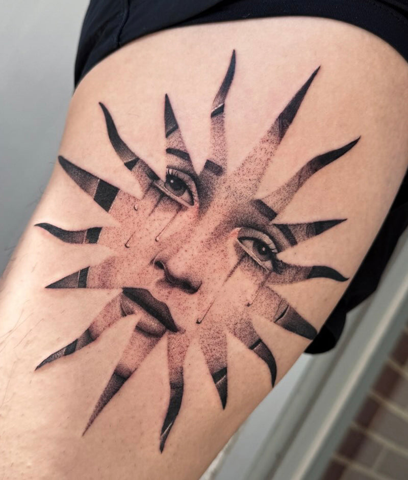 Black and grey illustrative sun face tattoo by Elise Likidis