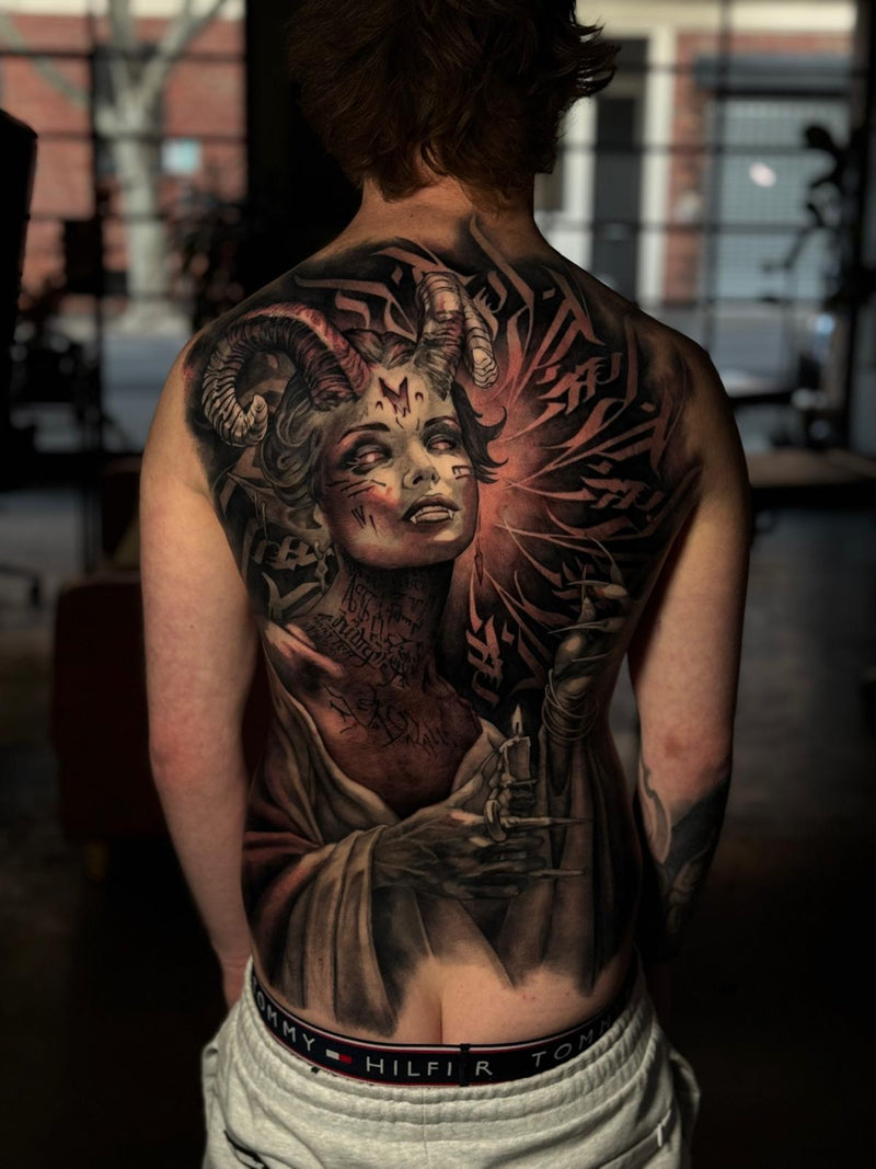 Black and grey realism backpiece of a woman and wings by Cody Wilson