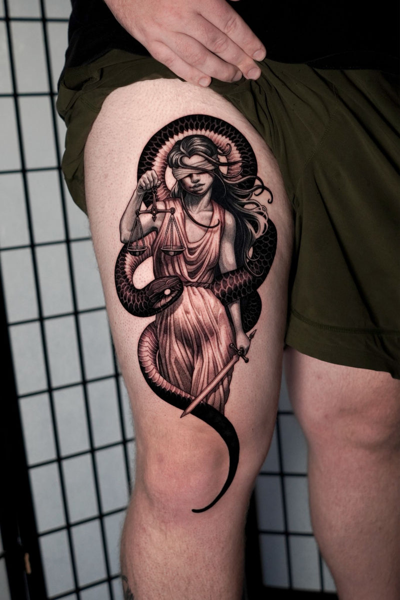 Woman and snake thigh tattoo by Ben Smith